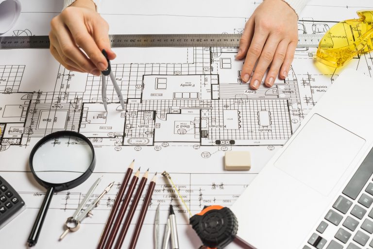 unrecognizable-architect-drawing-plan
